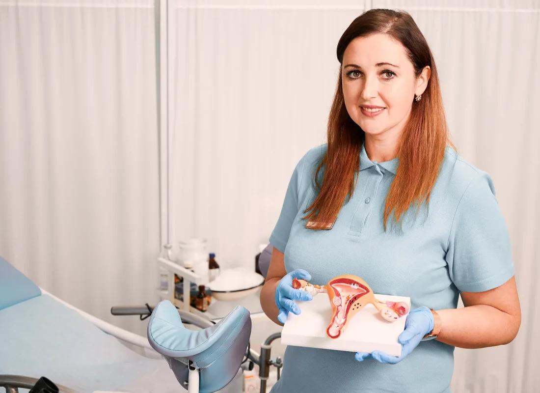 charming-female-doctor-holding-uterus-anatomy-model