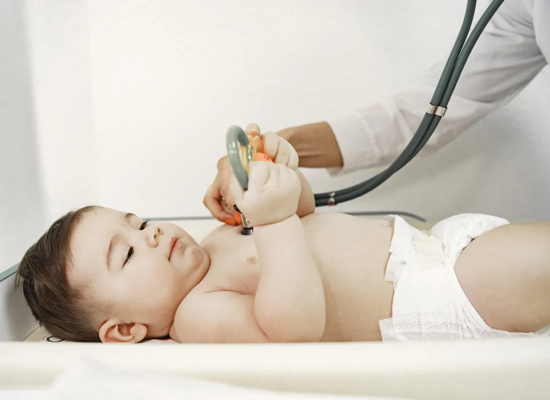 doctor-with-stethoscope-baby-without-clothes-examination-by-doctor