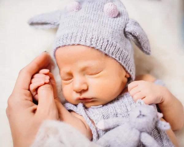 mother-holds-little-baby-cow-suit